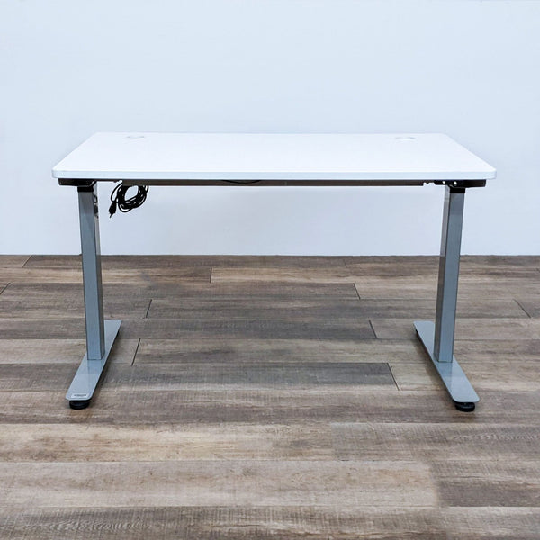 Alt text 1: A Reperch motorized, height-adjustable desk with a white top and gray steel frame, shown in the lowered position.