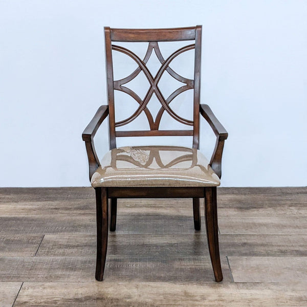 Alt text 1: Lattice back wooden dining armchair from Macy's with a beige upholstered seat, shown from the front on a wooden floor.