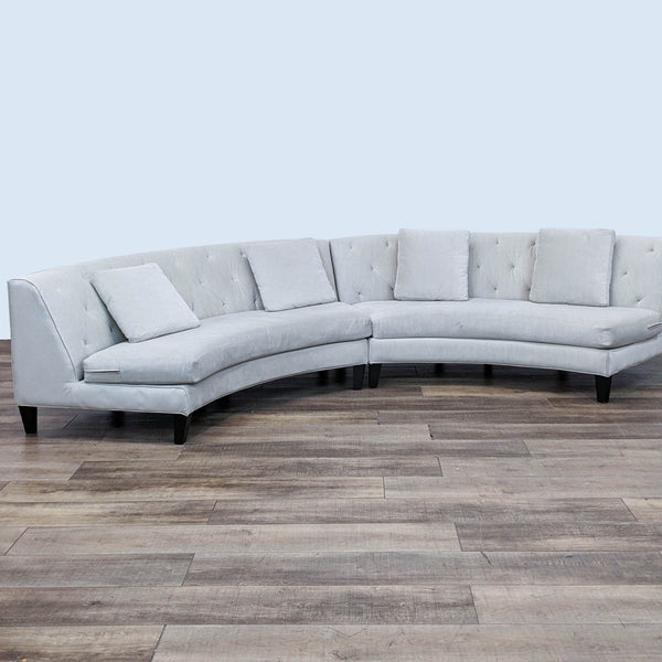 Alt text 1: Curved two-piece armless sectional with tufted backs and bench seat by Jonathan Louis in a light fabric on wood floors.