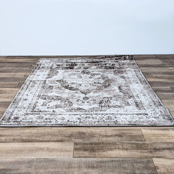 1. A Sofia Lt. Brown 6x9 area rug by Unique Loom, with a distressed design, displayed on a wooden floor.
