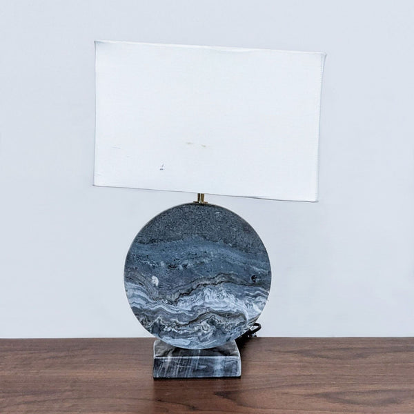Reperch-brand table lamp with a marbled base and rectangular white shade on a wooden surface.