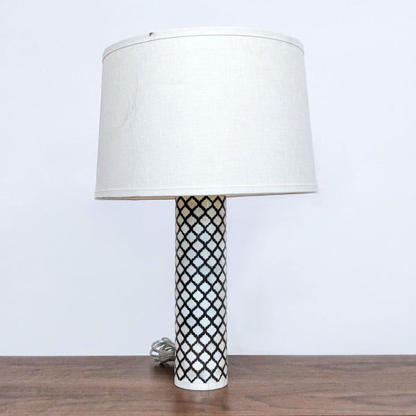Alt text 1: Reperch brand table lamp with a white fabric shade and a patterned cylindrical base on a wooden table.