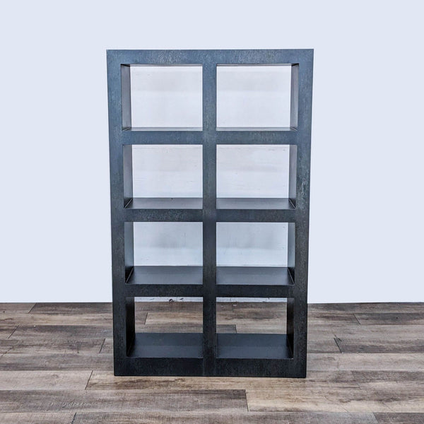Crate and Barrel steel bookshelf with graphite lacquer finish, shown in frontal view on a wooden floor.