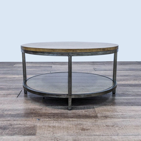 Reperch brand coffee table with a round wooden top on a metal frame, featuring a lower wooden shelf. Neutral background.
