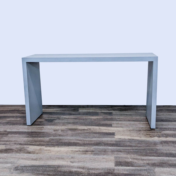 Deskmakers Parsons counter-height table with a gray finish and minimalistic design, showcased on a wooden floor.