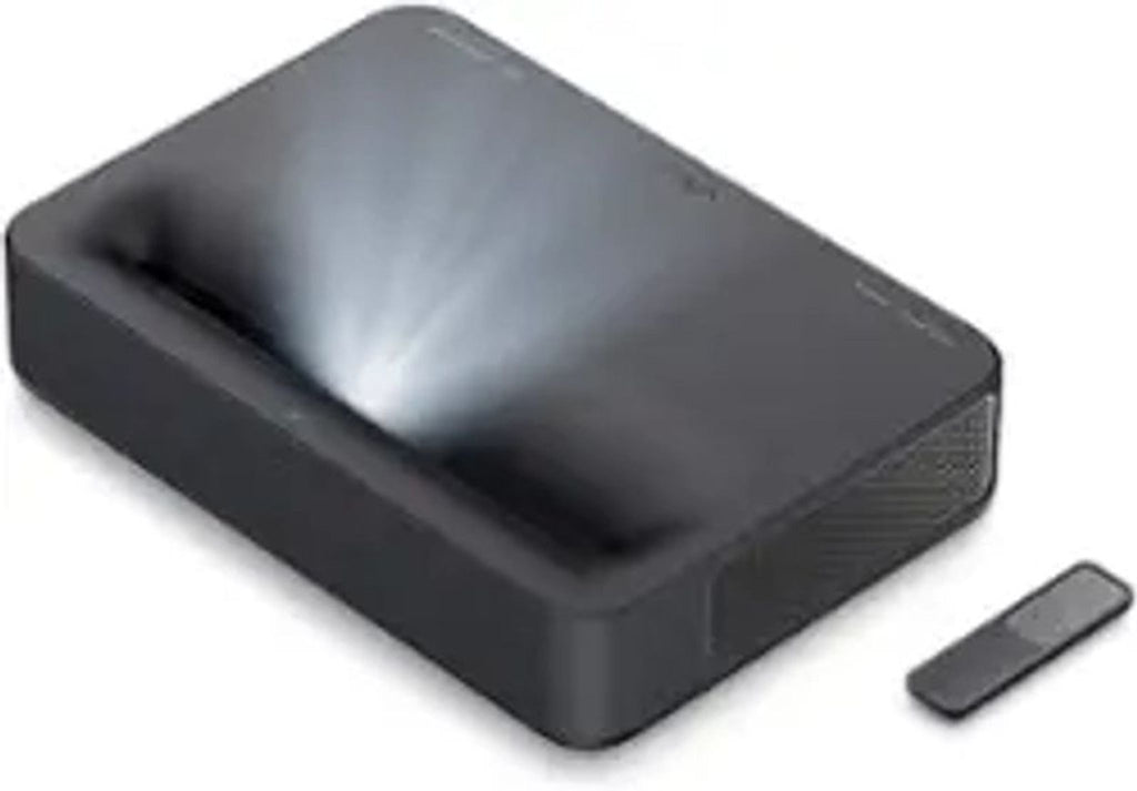 Side view of VAVA Chroma 4K Projector emitting light, with remote placed nearby.