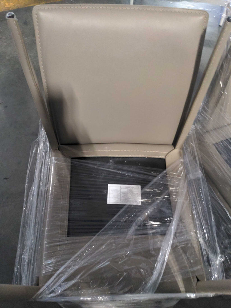 1. Beige dining chair with padded back and seat, partially wrapped in plastic for protection, viewed from above.