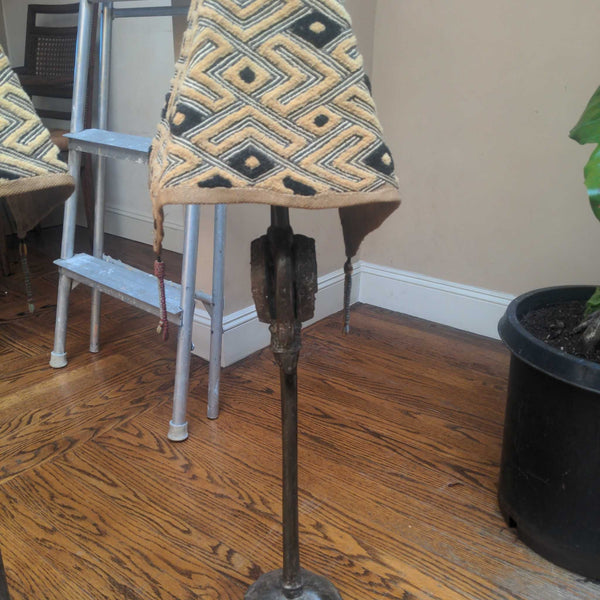 1. Table lamp with metal base and geometric-patterned fabric shade, placed on wooden floor near a plant.  