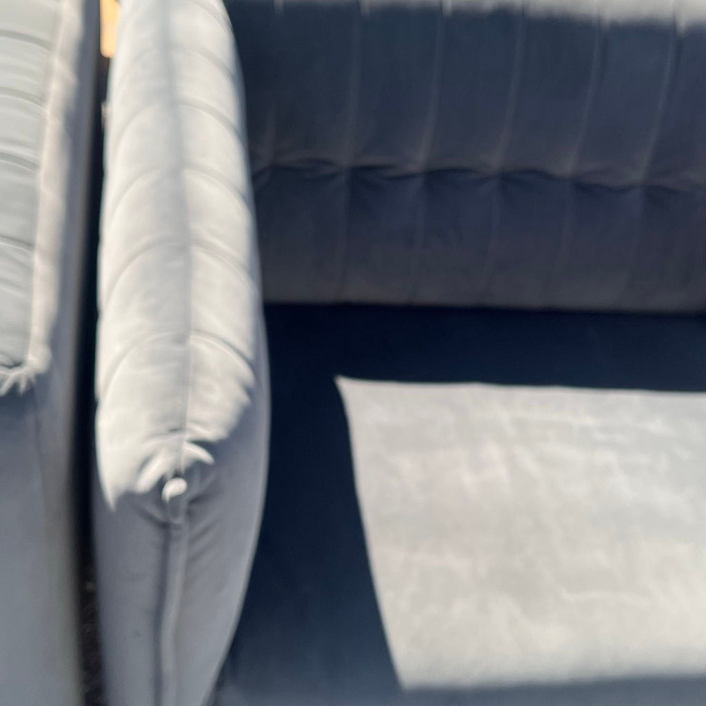 3. Two modern gray lounge couches with soft cushions, positioned outdoors under direct sun.