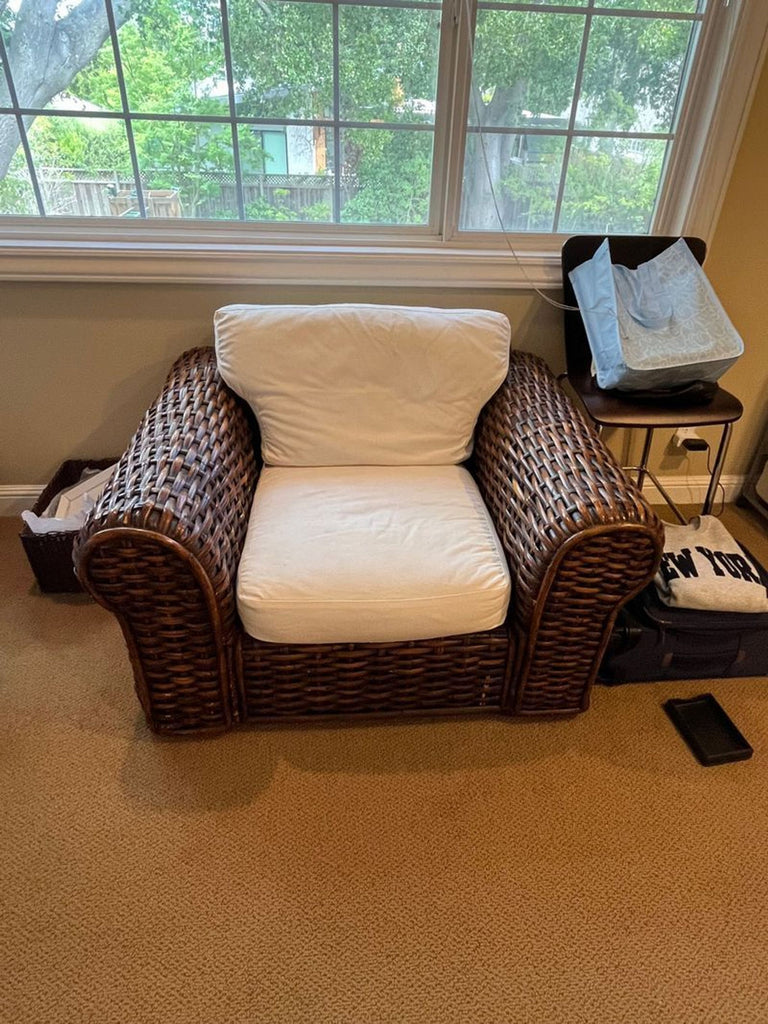 1. Modern lounge chair with plush cushions on a wooden frame, perfect for relaxing in living spaces.