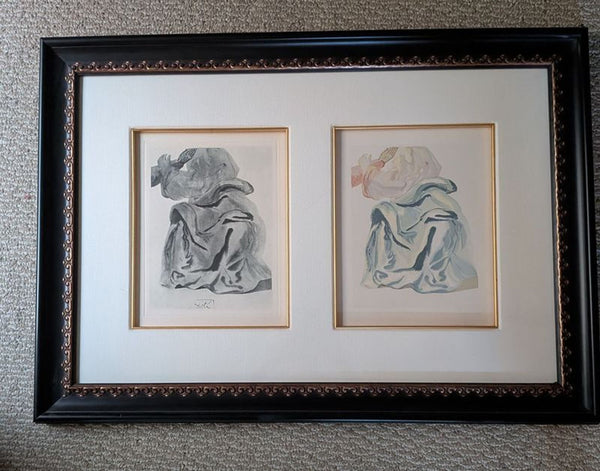 1. Framed side-by-side black-and-white and color sketches of a robed figure, displayed on a fabric surface.