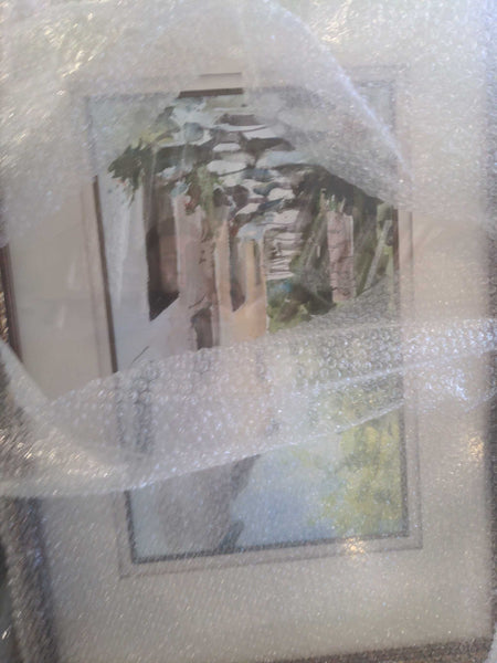 1. Framed painting of a shaded walkway covered in bubble wrap, watercolor style with foliage and light colors.