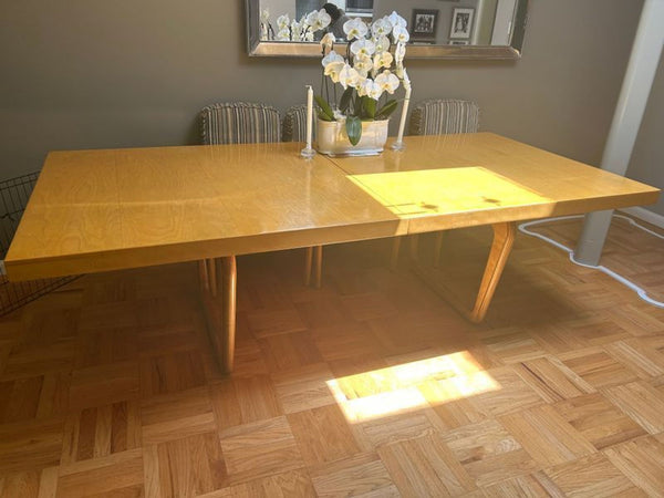 1. Reperch dining set with large wooden table and leaf, styled with a floral centerpiece, in a dining room.