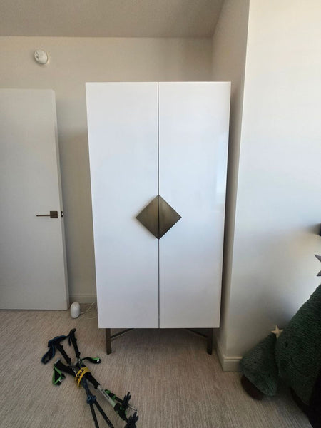 Sleek modern CB2 Astoria wardrobe cabinet with double doors and minimalist metal handles.