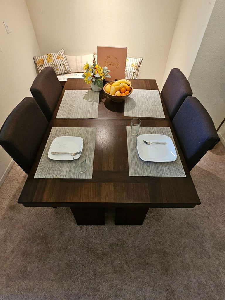 1. Norcal Furnitures dining set featuring sleek table and matching chairs, perfect for contemporary dining spaces.