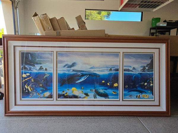 Framed three-panel artwork showing whales, sea turtles, and colorful fish in a vivid blue underwater scene.