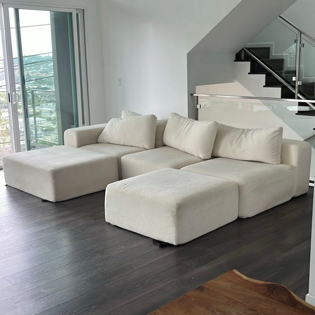 Diorama sectional couch with flexible layout, plush cream upholstery, roomy seats, and ottomans, perfect for modern homes.
