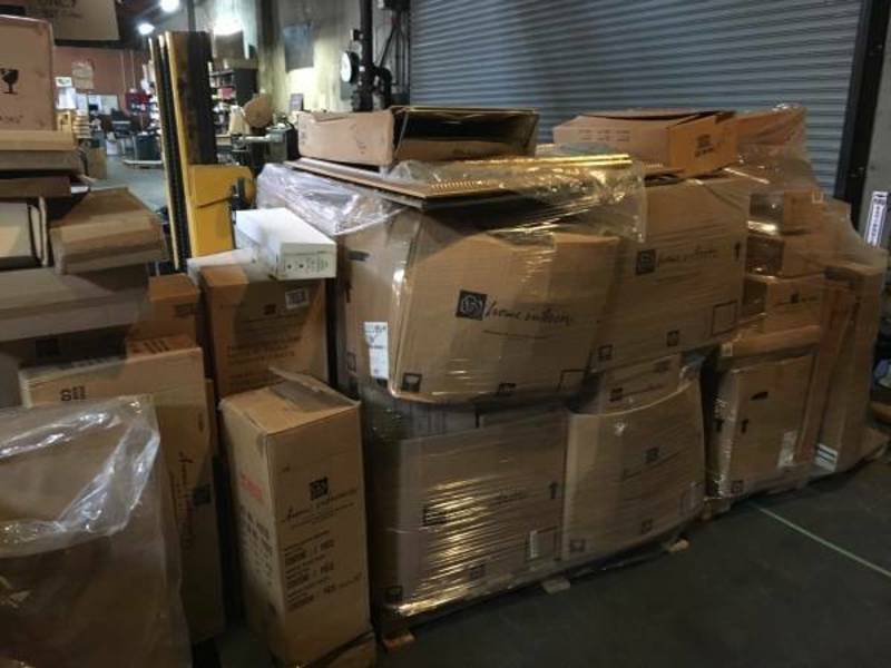 2. Multiple large and small Reperch boxes wrapped in plastic shrink wrap, stored in an industrial warehouse.