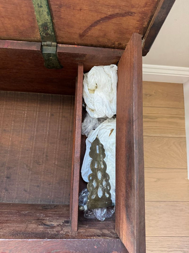 Open chest interior showing a spare lock, emphasizing the trunk's detail and craftsmanship.