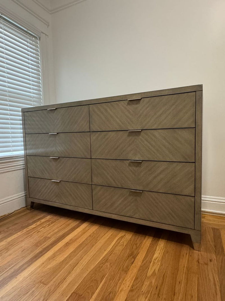 2. Modern Williams Sonoma Home dresser featuring sleek metal handles and a chevron-pattern veneer, shown on hardwood floor.