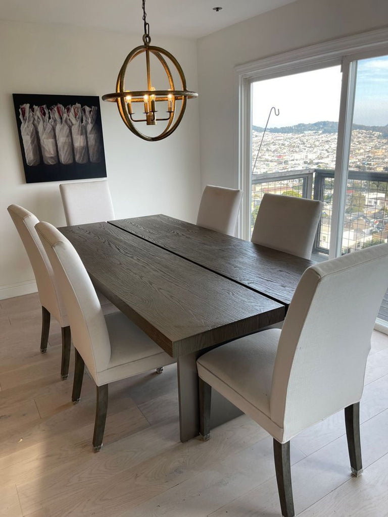 Cream linen dining chairs from Restoration Hardware, shown as part of an elegant dining set.