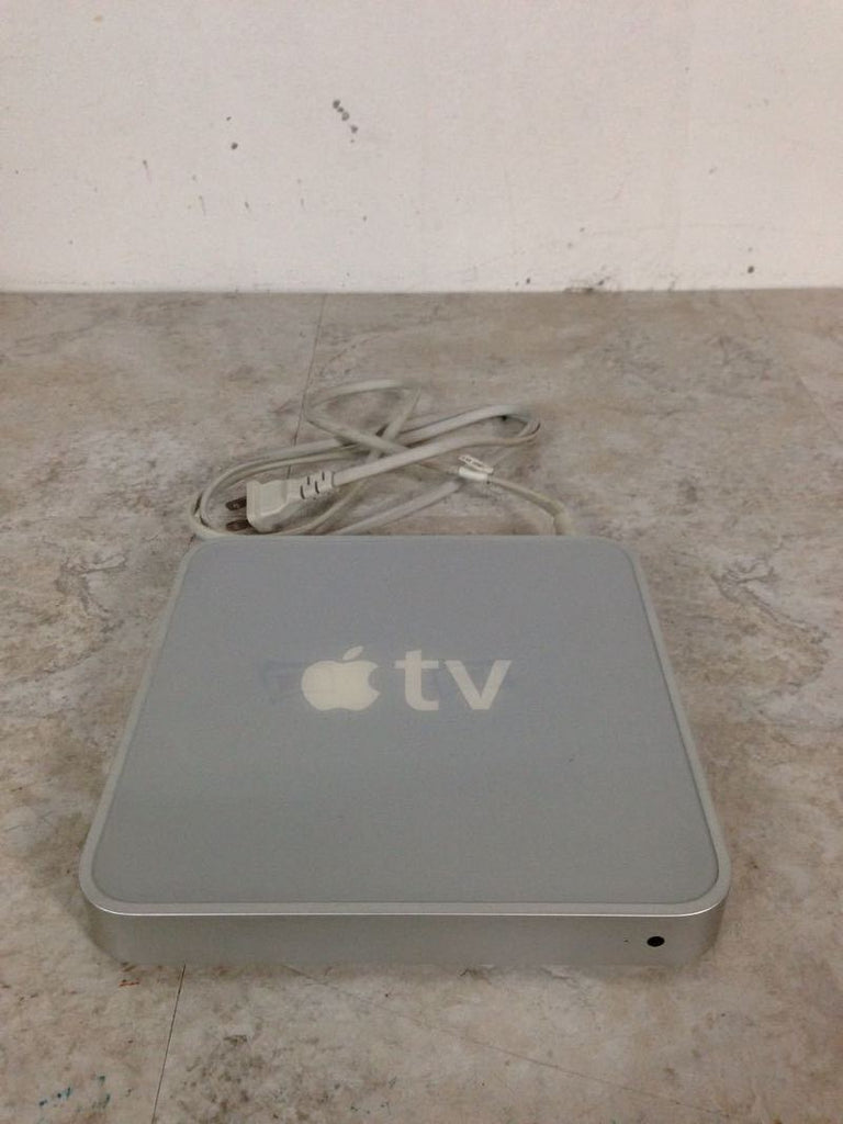 1. Apple TV A1218 media player with power cord, showing top view and "tv" logo, category Other, brand Apple.  