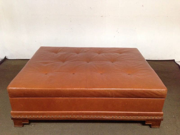 1. Reperch coffee table with geometric feet, brown tufted leather top, nailhead trim, and lift-top storage.