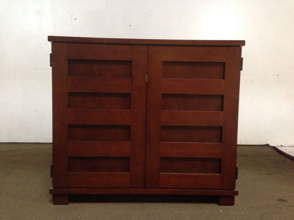 1. Dark wood entertainment center with two doors featuring geometric panels, designed for interior storage, closed view.