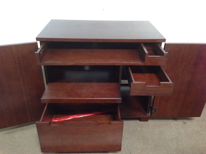 3. Entertainment center by Crate & Barrel shown open, revealing multiple drawers, shelves, and compartments for storage.