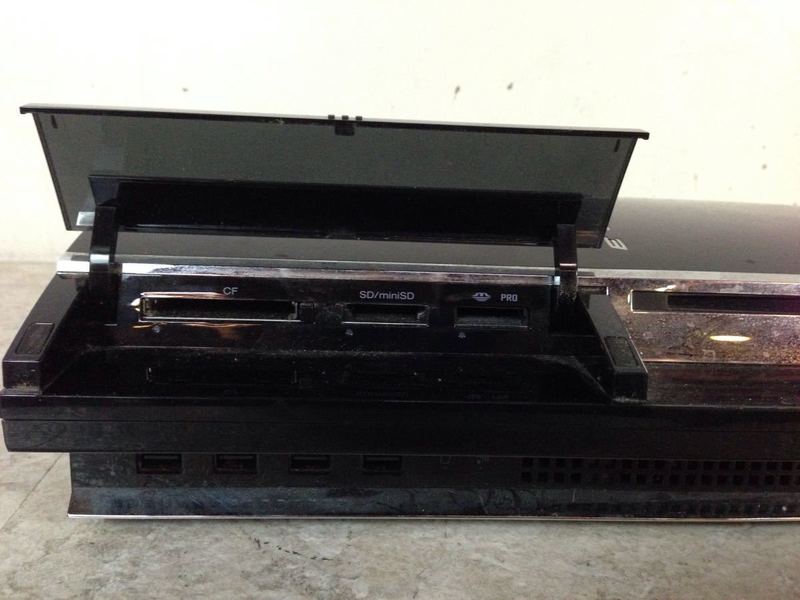 2. Close-up of Sony PlayStation 3 CECHA01 front panel showing open card reader slots for CF, SD, and Pro cards.