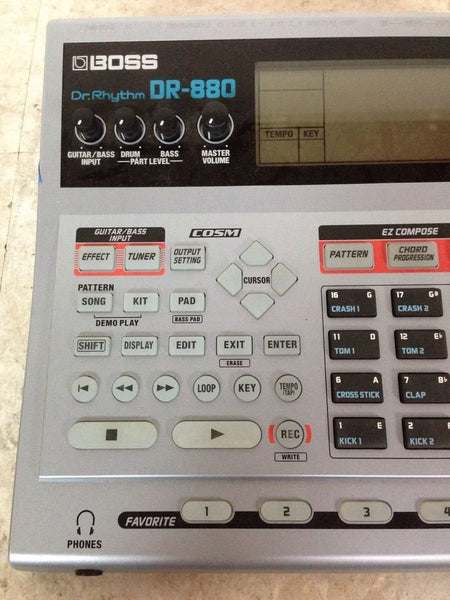 1. Close-up of Boss DR-880 Dr. Rhythm controls, showing screen, dials, and preset buttons from audio equipment.
