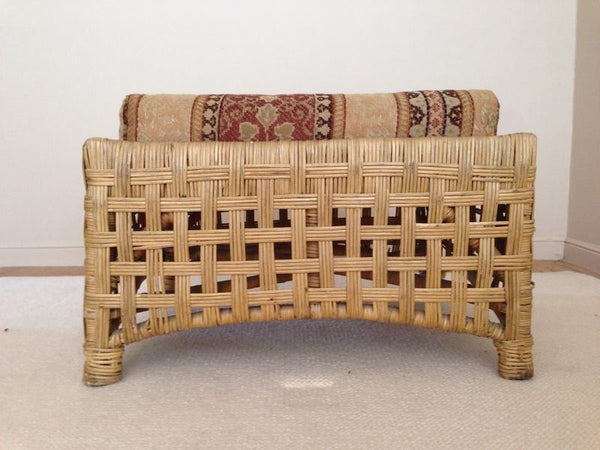 1. Woven rattan Reperch chair with raised legs and cushion featuring striped foliate prints, front view.