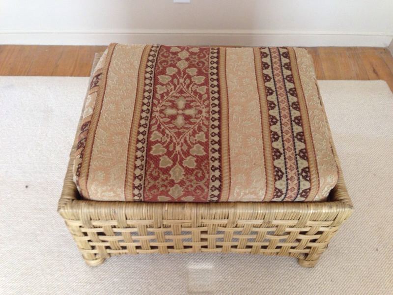 2. Top view of a Reperch chair showcasing striped, foliate-patterned cushion on a woven rattan base.