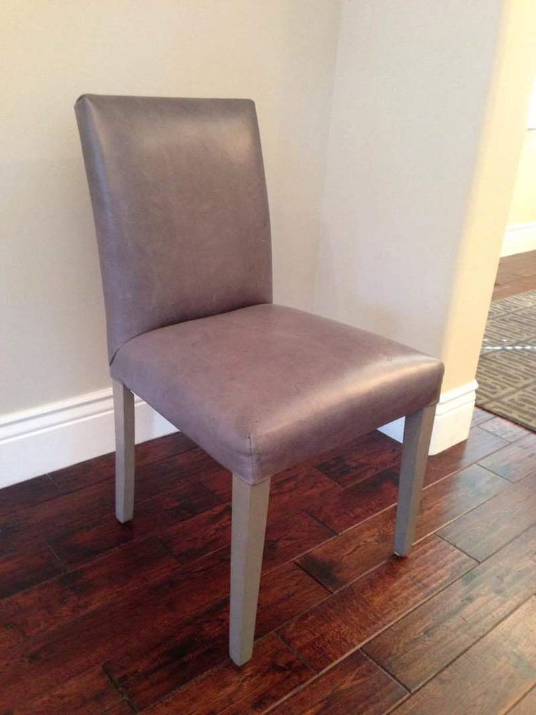 2. Side angle view of Reperch chair, featuring grey upholstery and sturdy wooden legs, for home or office use.