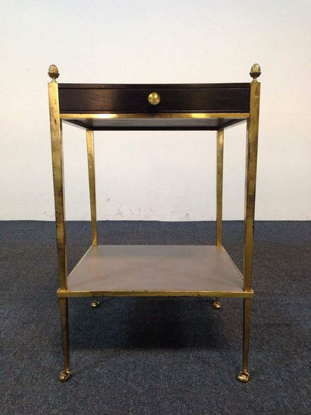 1. Reperch side table with gold metal frame, a dark wood drawer, and decorative finials on each corner.  