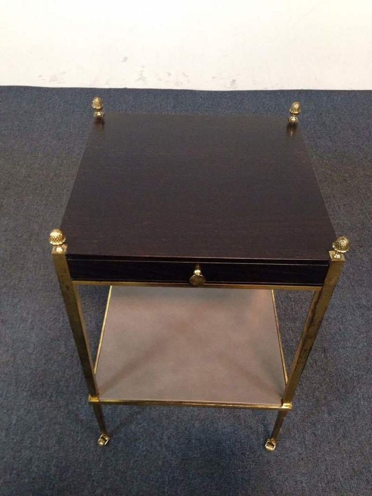 2. Top view of a Reperch side table, showing dark wood surface and four gold decorative corners.  