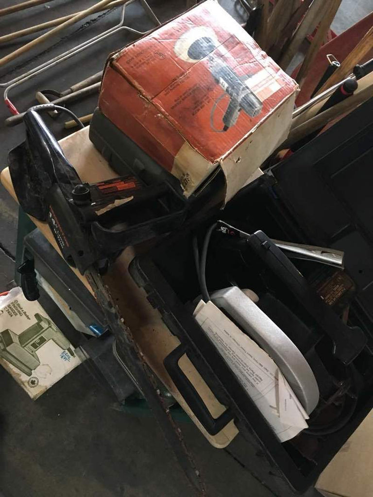 2. Close-up of Reperch power tools, boxed sanders, and saws scattered for household and yard maintenance tasks.