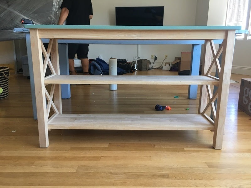 3. Reperch two-tier bookshelf with green top, open wooden shelves, and decorative X-pattern on the sides.