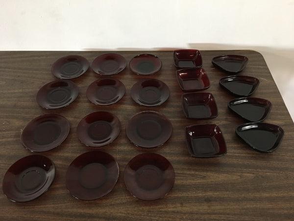 1. Collection of vintage red Anchor Hocking glass plates and bowls arranged on a wooden surface.