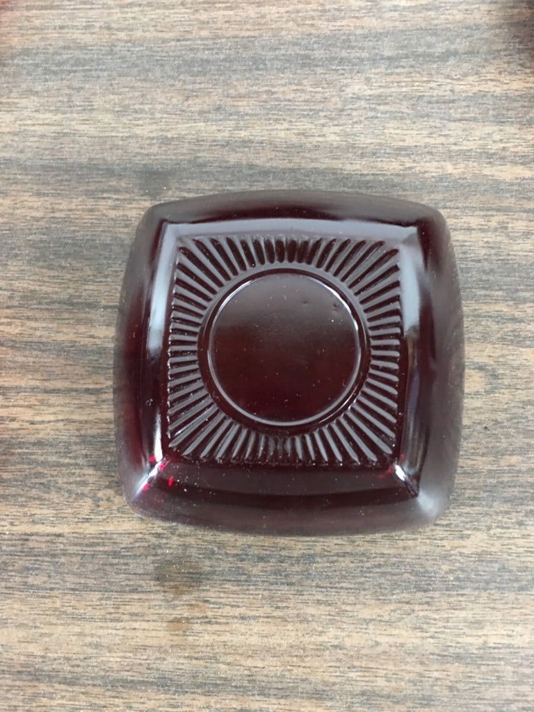 2. Close-up of a square vintage red glass bowl by Anchor Hocking with a decorative bottom design.