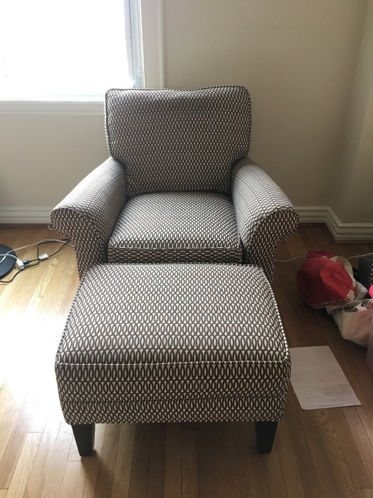 1. Pottery Barn armchair and ottoman set with geometric-patterned neutral upholstery on hardwood floor.
