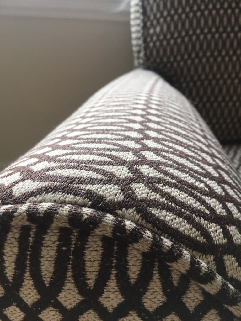 3. Close-up of Pottery Barn chair arm showing detailed textured weave and geometric pattern upholstery.