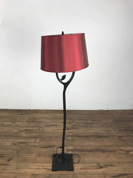 1. Reperch floor lamp in great condition with a red lampshade and black stand on a wooden floor.  
