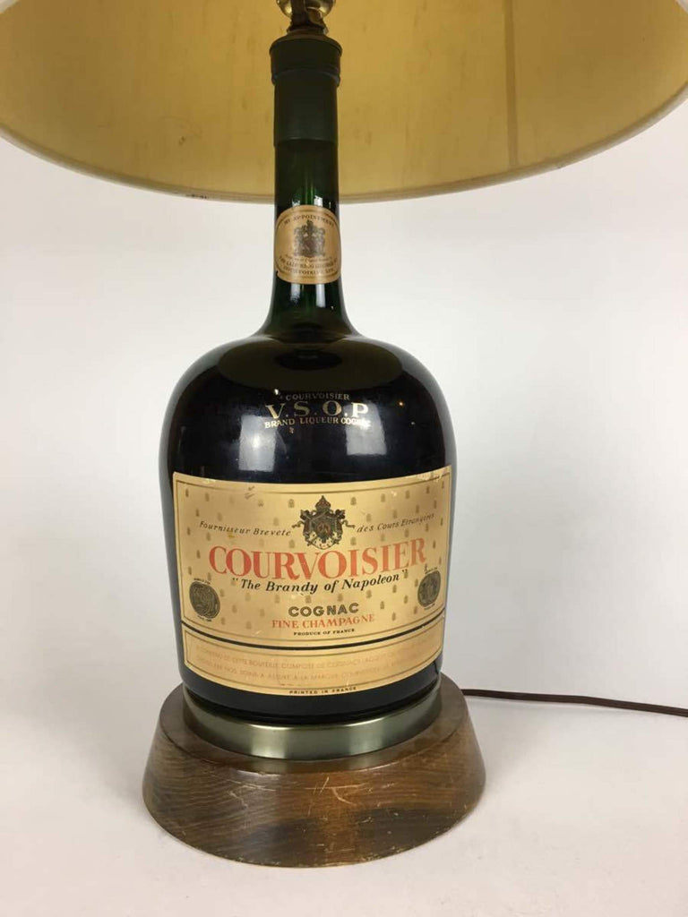 2. Close-up of a Reperch lamp base, featuring a Courvoisier VSOP cognac bottle and wooden stand.