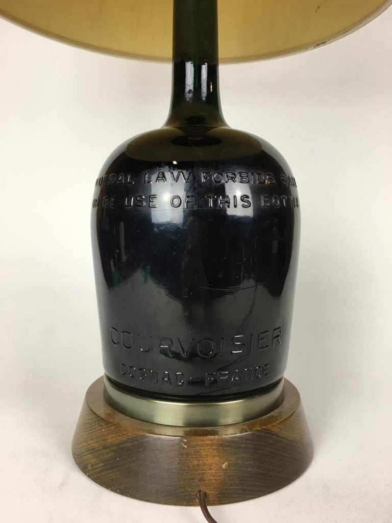 3. Rear side detail of a Reperch lamp showing embossed Courvoisier branding on the bottle base.