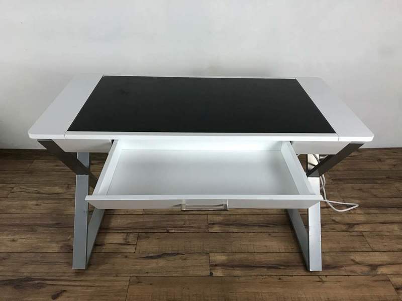 2. Sleek electrified office desk by Reperch featuring metal X-frame legs and an open central drawer.