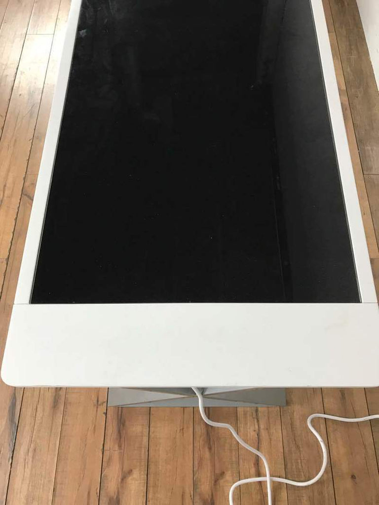 3. Top view of a Reperch desk showing white frame, black surface, and power cord, ideal for office use.