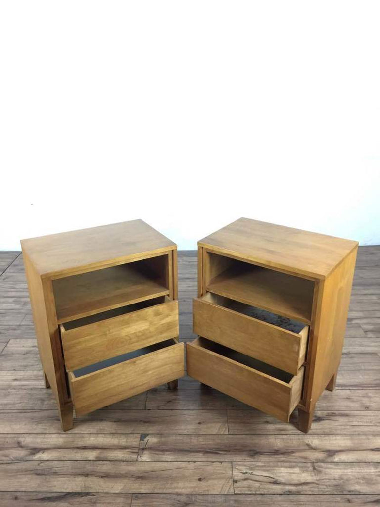 2. Two Conant Ball end tables featuring open shelves on top and opened lower drawers on a wooden floor.