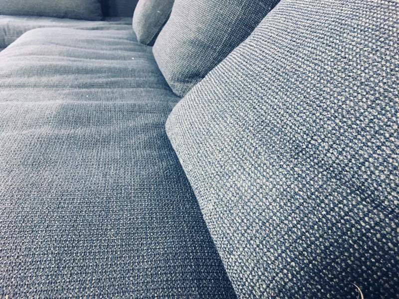 Close-up of textured dark fabric upholstery and cushions on a B&B Italia Italian-designed sofa.