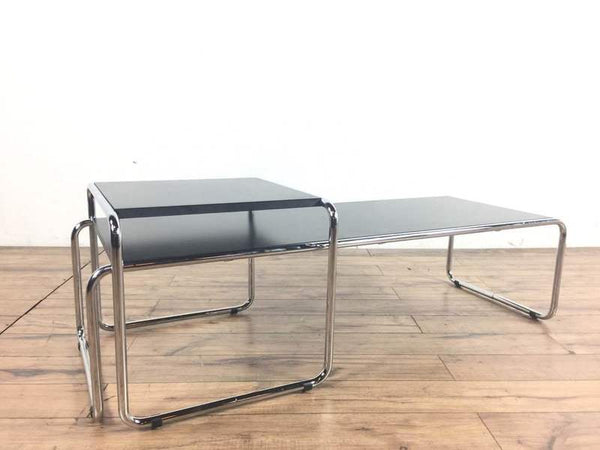 1. Modern Knoll coffee table with Bauhaus influence, featuring black surfaces and chrome tubular frame, side view.